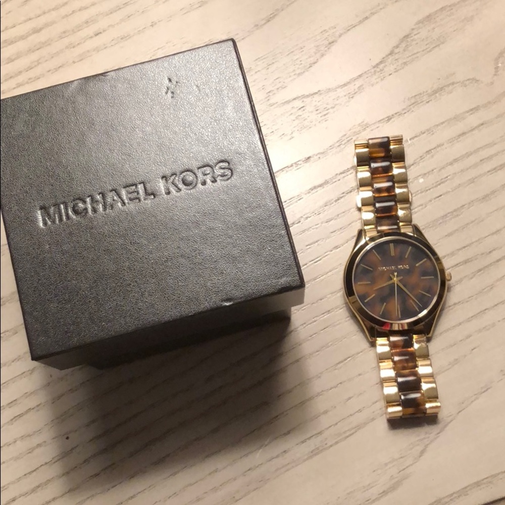 gold and brown Michael Kors women’s watch